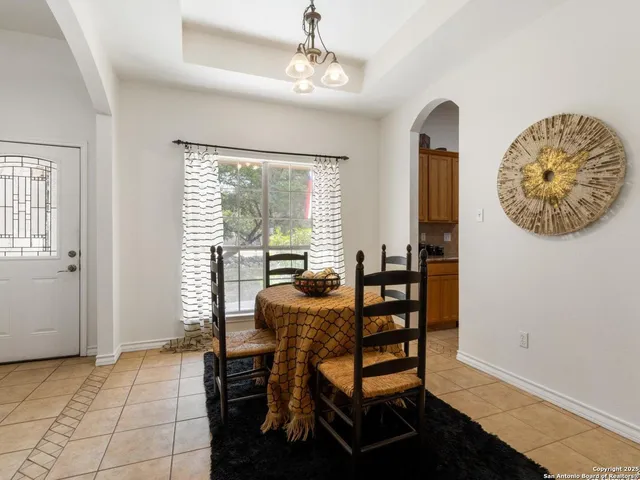a view of a dining room with furniture and a window