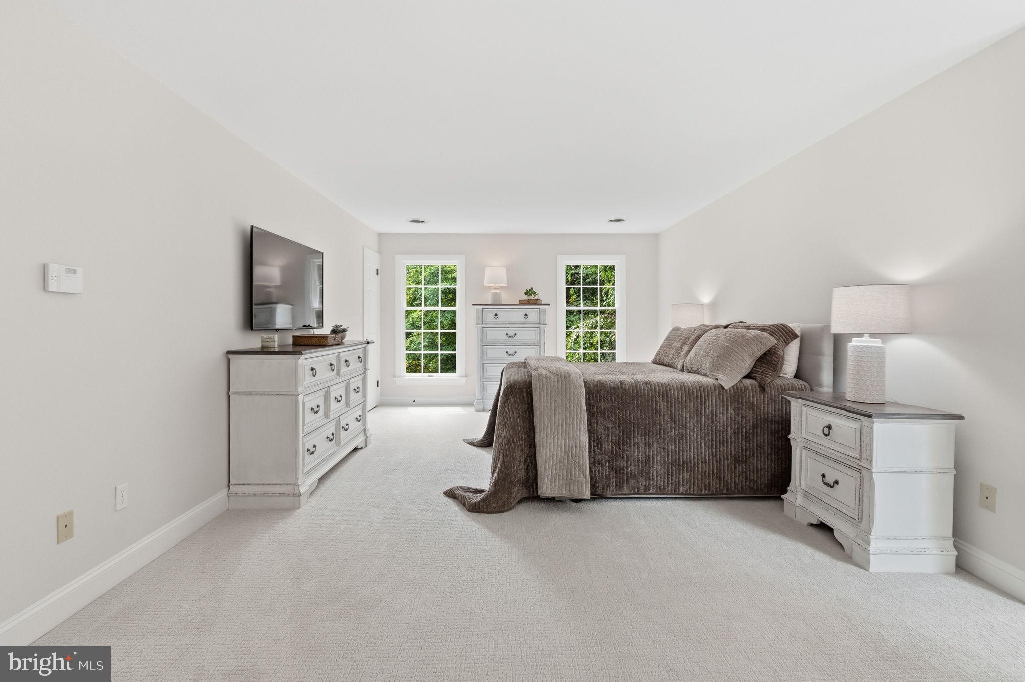2971 Comfort Road New Hope, PA 18938 - Photo 28 of 60 a spacious bedroom with a bed and a flat screen tv