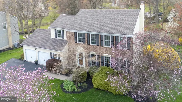 a aerial view of a house with yard and green space