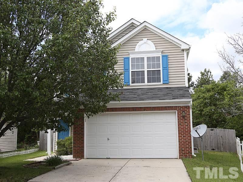 4205 Toccopola Street Raleigh, NC 27604 - Photo 1 of 24 a front view of a house with a yard and garage
