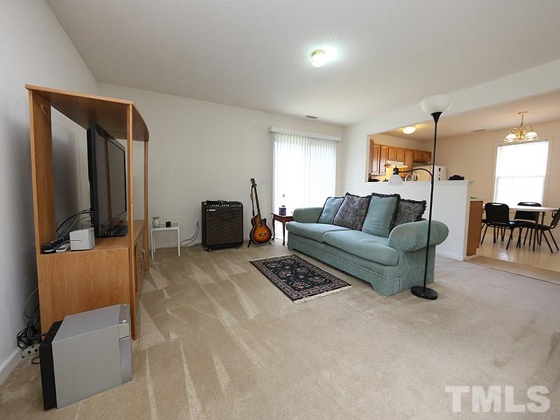4205 Toccopola Street Raleigh, NC 27604 - Photo 2 of 24 a living room with furniture and a lamp