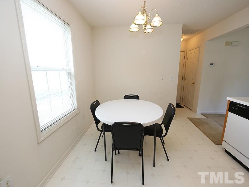 4205 Toccopola Street Raleigh, NC 27604 - Photo 13 of 24 a view of a dining room with furniture and chandelier