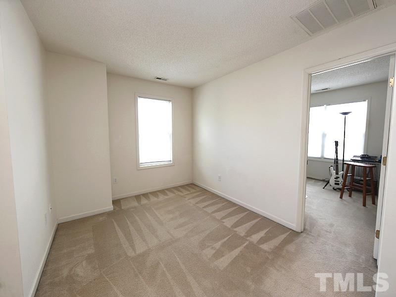 4205 Toccopola Street Raleigh, NC 27604 - Photo 14 of 24 an empty room with furniture and a window