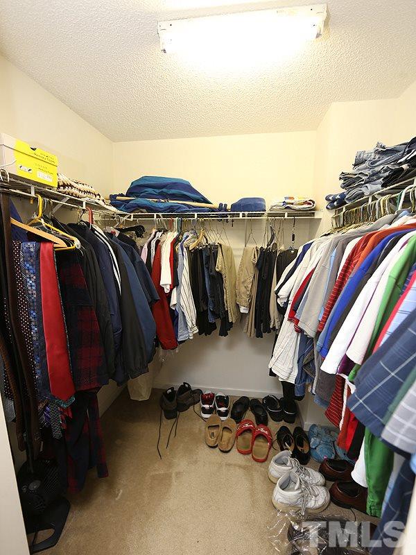 4205 Toccopola Street Raleigh, NC 27604 - Photo 5 of 24 a view of walk in closet with clothes and shoes