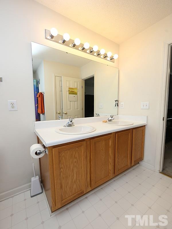 4205 Toccopola Street Raleigh, NC 27604 - Photo 6 of 24 a bathroom with a double vanity sink and a mirror