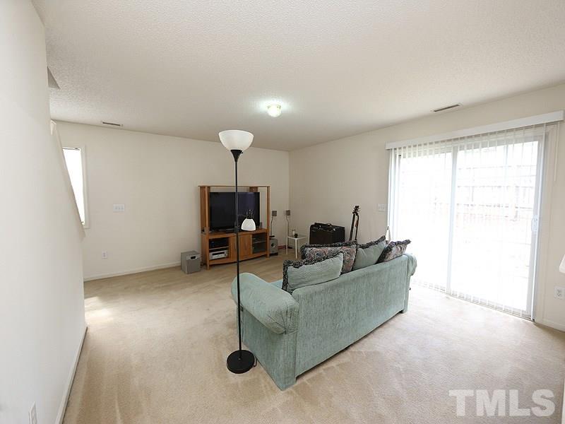 4205 Toccopola Street Raleigh, NC 27604 - Photo 9 of 24 a living room with furniture and a flat screen tv