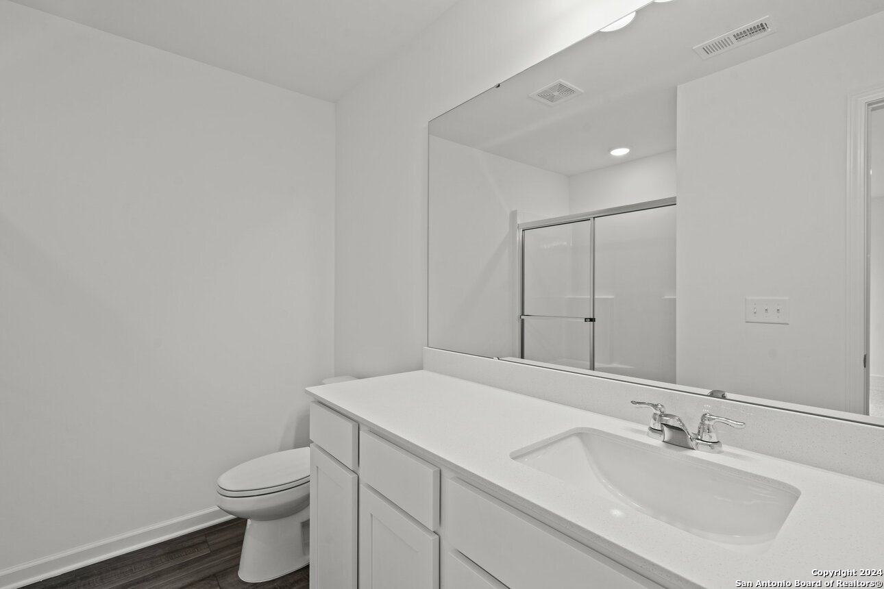 1428 Almeda Road Seguin, TX 78155 - Photo 17 of 17 a bathroom with a sink toilet and vanity