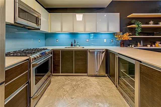 a kitchen with stainless steel appliances granite countertop a stove and a sink