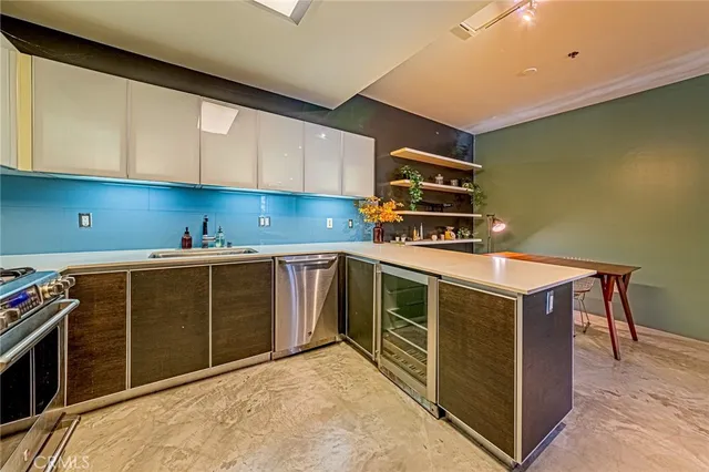 a kitchen with stainless steel appliances a stove and cabinets