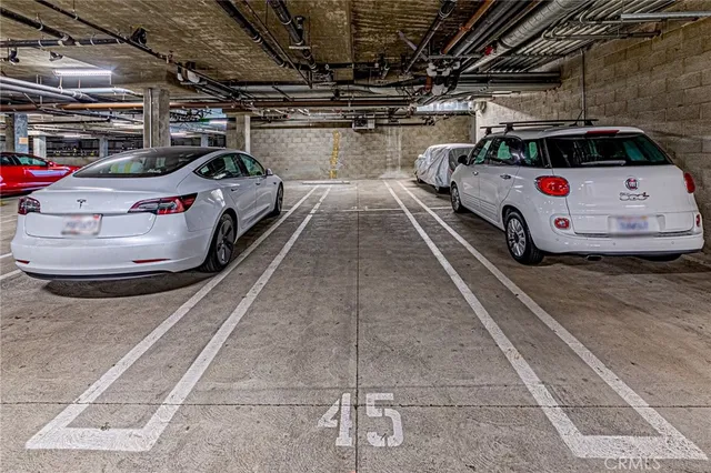 a view of parking garage with cars parked