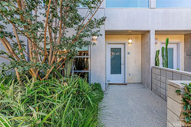 an entrance to house with yard and glass windows