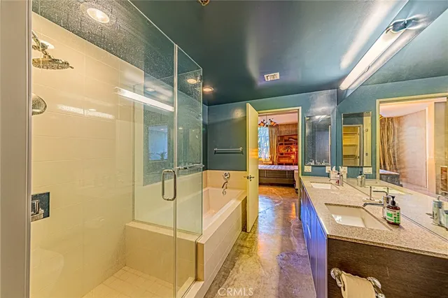 a bathroom with a tub sink and mirror