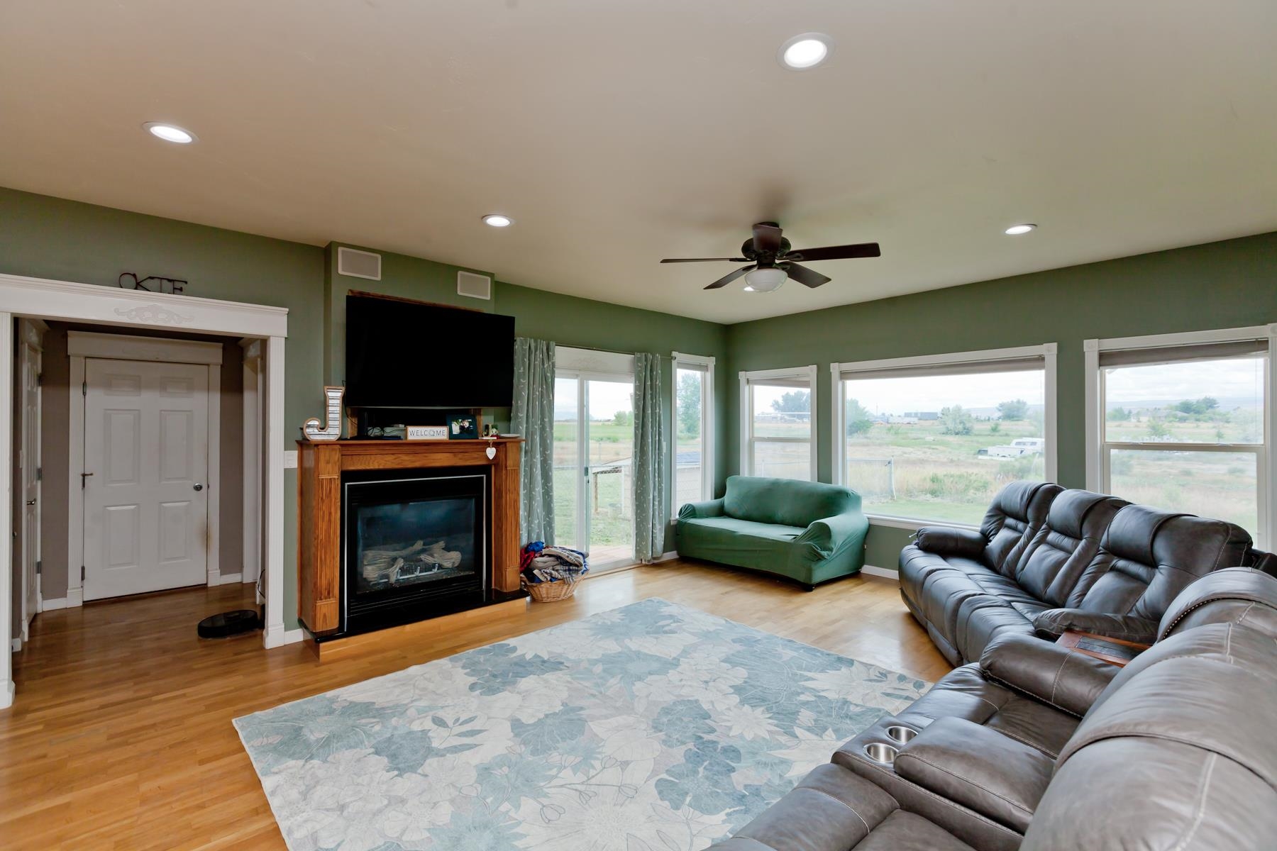1815 O Road Fruita, CO 81521 - Photo 14 of 42 a living room with furniture a fireplace and a flat screen tv