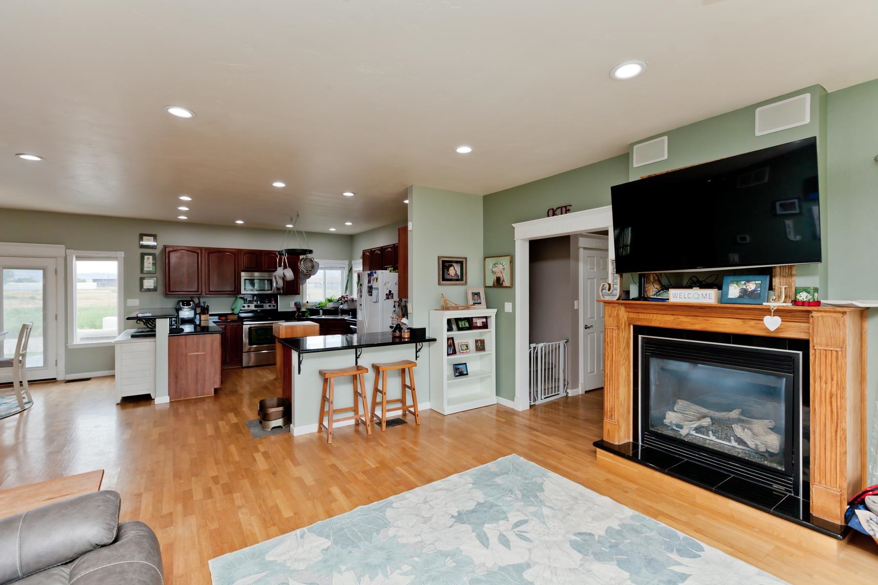 1815 O Road Fruita, CO 81521 - Photo 15 of 42 a living room with furniture a flat screen tv and a fireplace