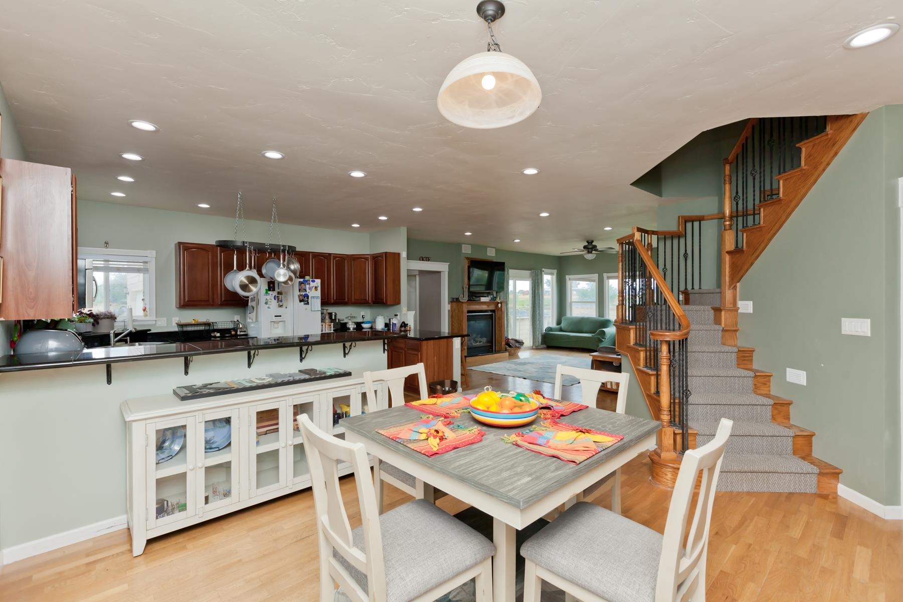 1815 O Road Fruita, CO 81521 - Photo 20 of 42 a kitchen with stainless steel appliances kitchen island granite countertop a table chairs and a stove