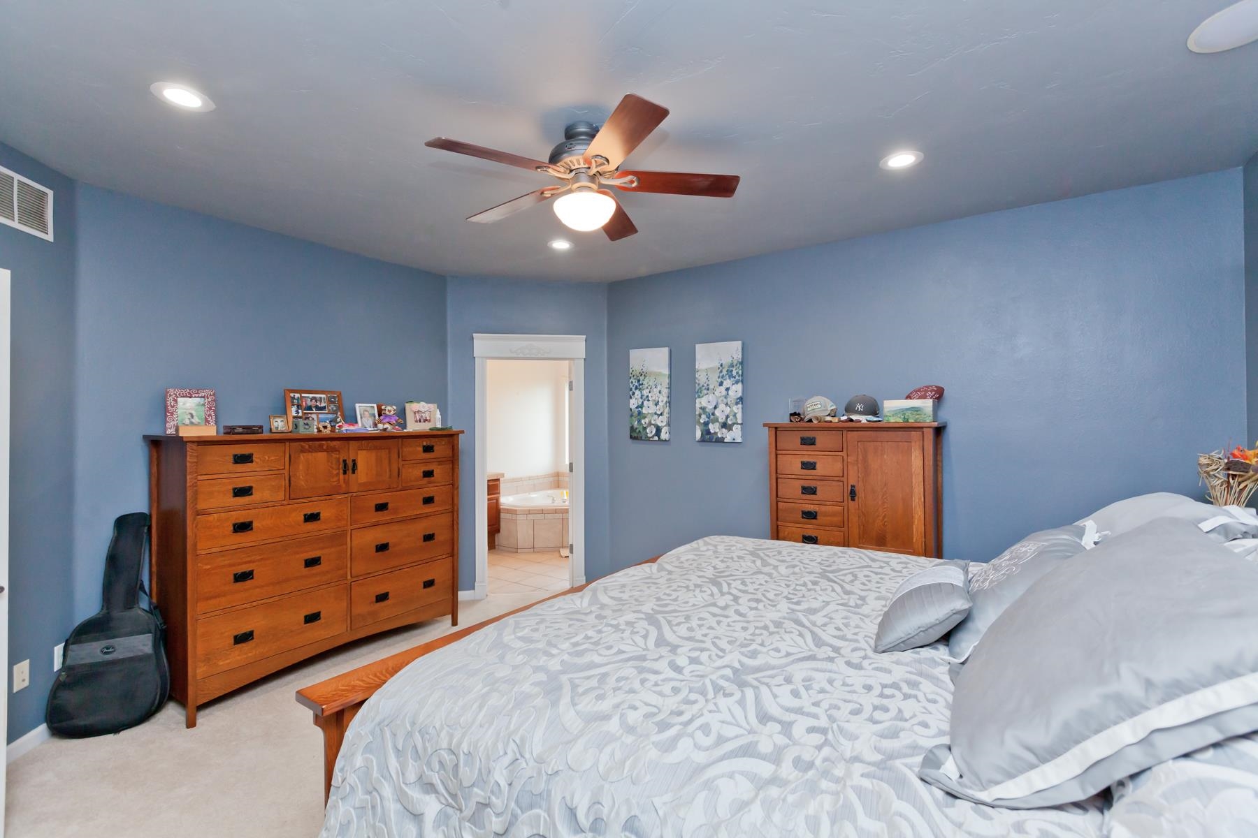 1815 O Road Fruita, CO 81521 - Photo 25 of 42 a bedroom with a dresser and a chandelier