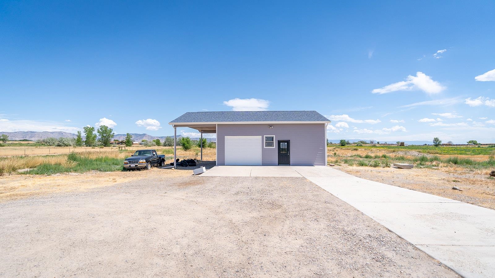 1815 O Road Fruita, CO 81521 - Photo 5 of 42 a view of a house with a yard and ocean view
