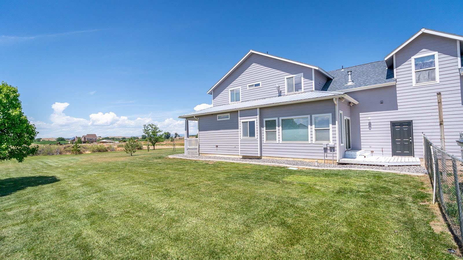 1815 O Road Fruita, CO 81521 - Photo 7 of 42 a view of a house with a yard and sitting area