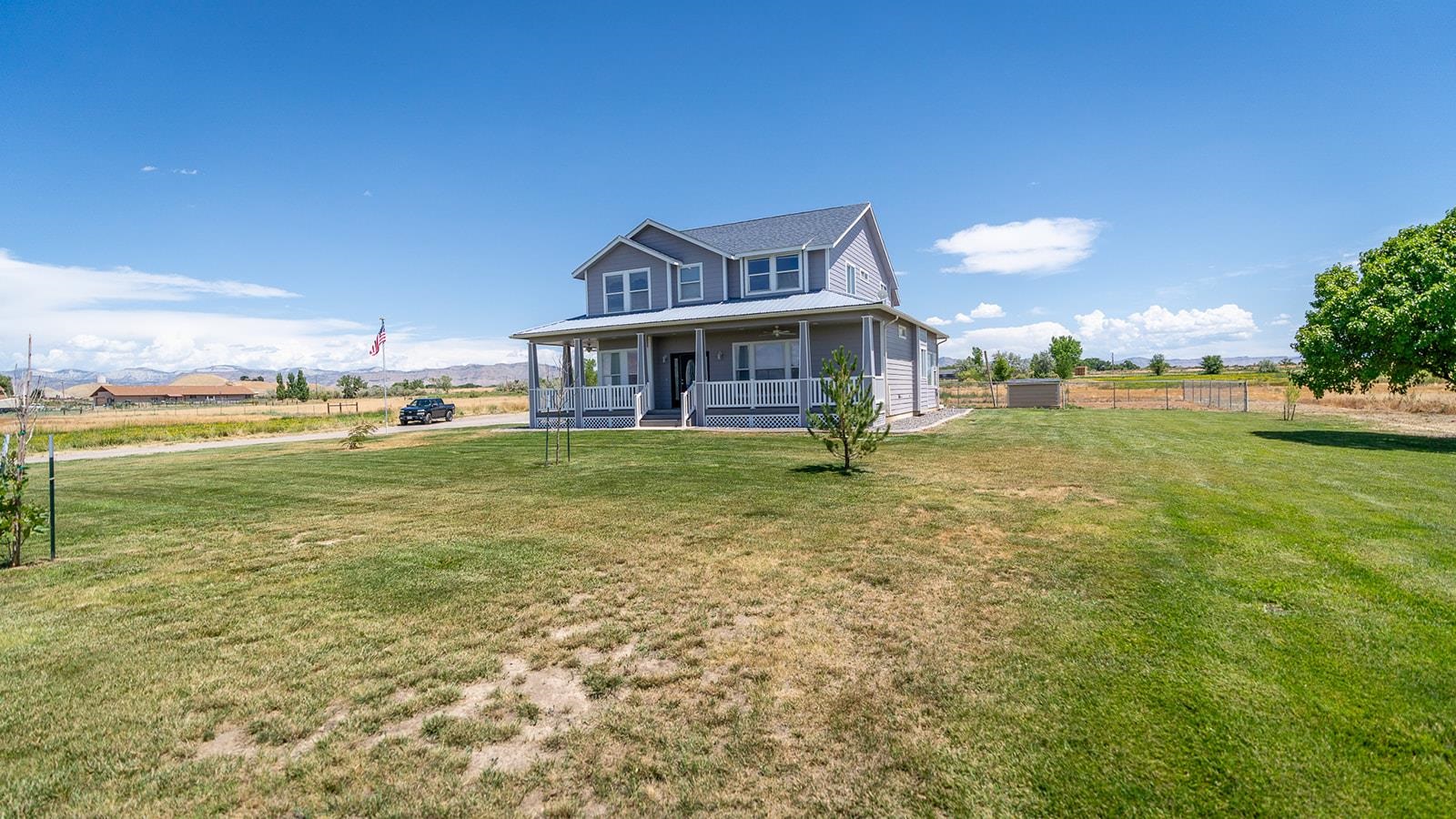 1815 O Road Fruita, CO 81521 - Photo 9 of 42 a view of a house with a yard and sitting area