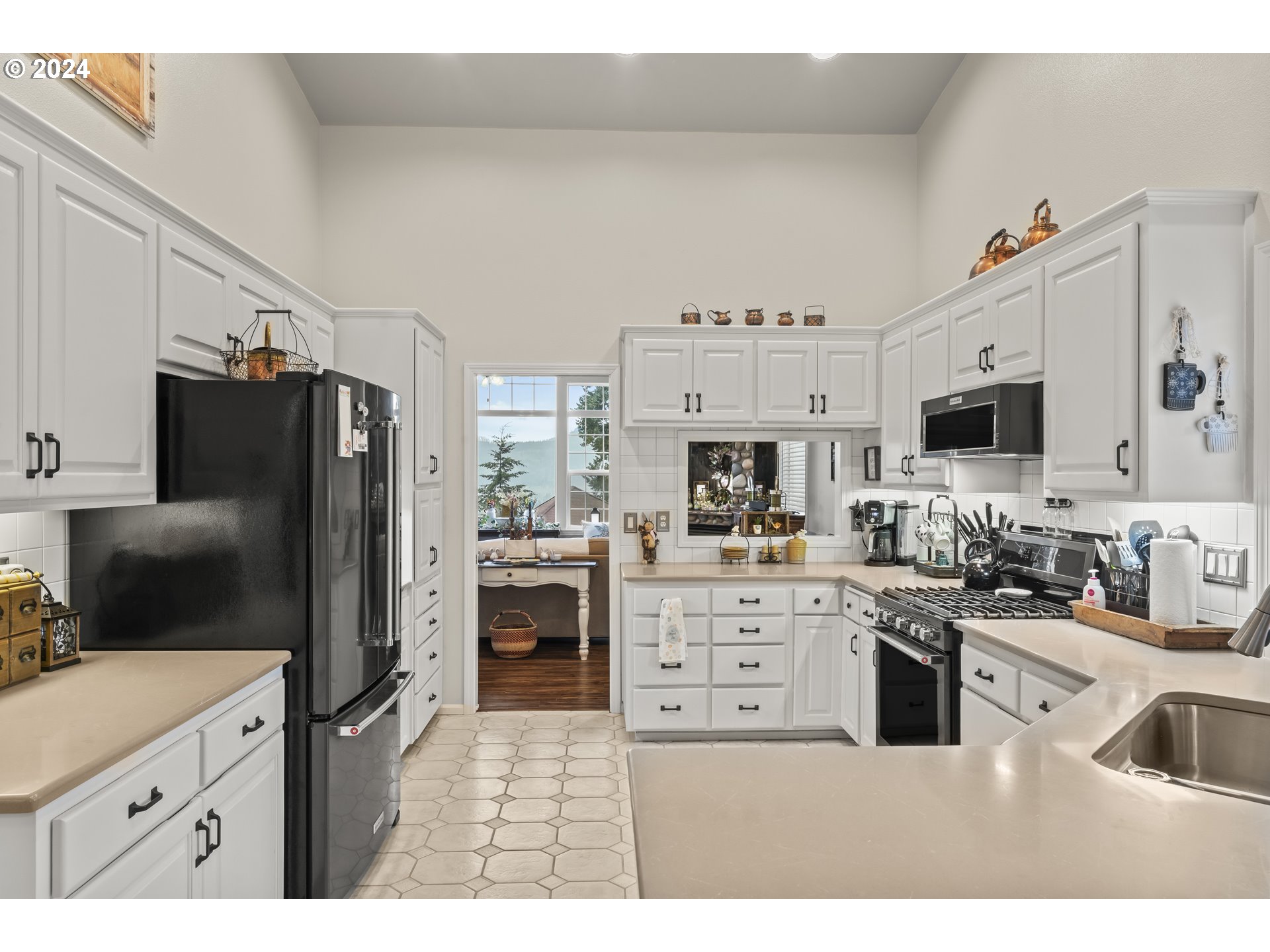 6737 Ivy Street Springfield, OR 97478 - Photo 18 of 48 a kitchen with stainless steel appliances a stove refrigerator sink and microwave