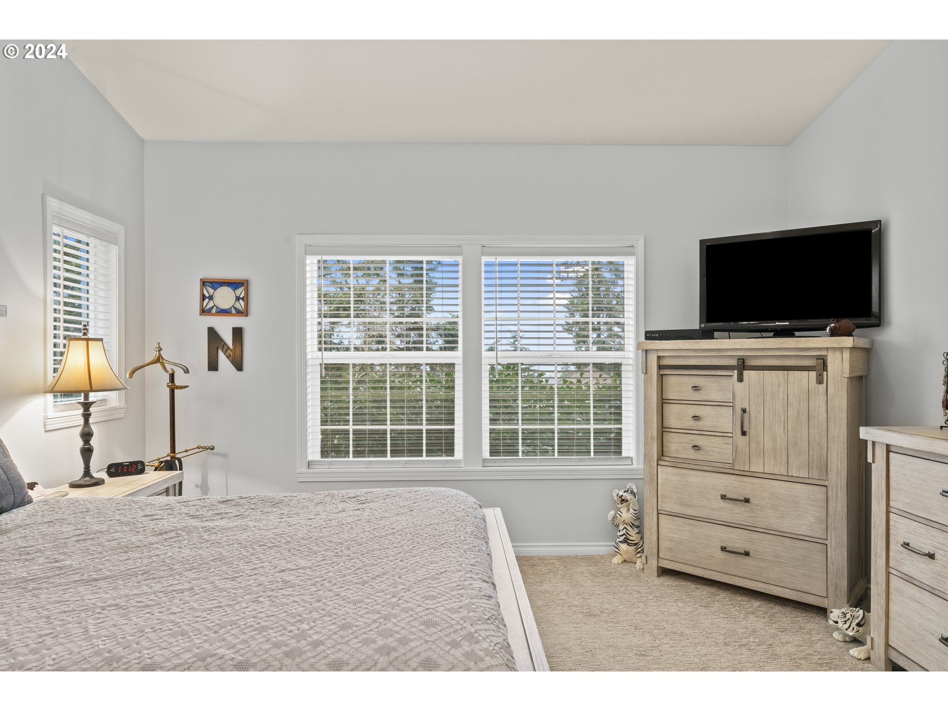6737 Ivy Street Springfield, OR 97478 - Photo 35 of 48 a bedroom with a bed and a flat screen tv
