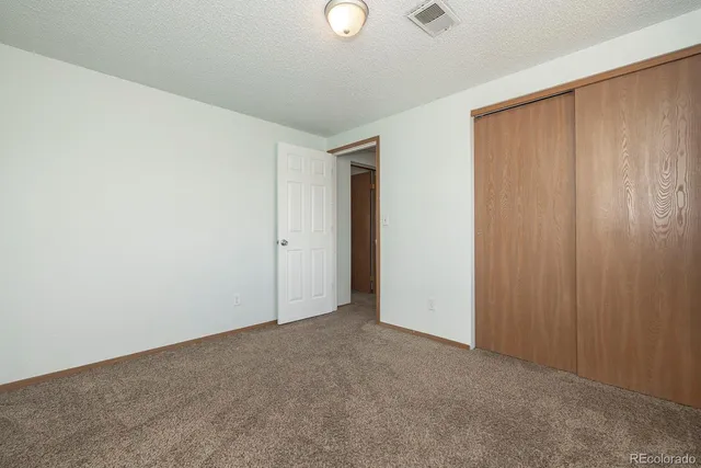 an empty room with closet area