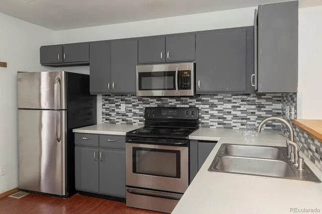 a kitchen with a stove microwave and refrigerator