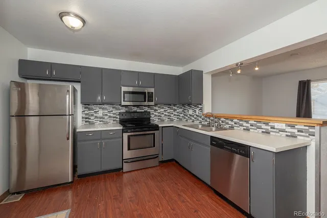 a kitchen with stainless steel appliances and wooden cabinets
