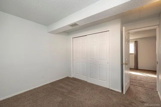 an empty room with mirror in kitchen