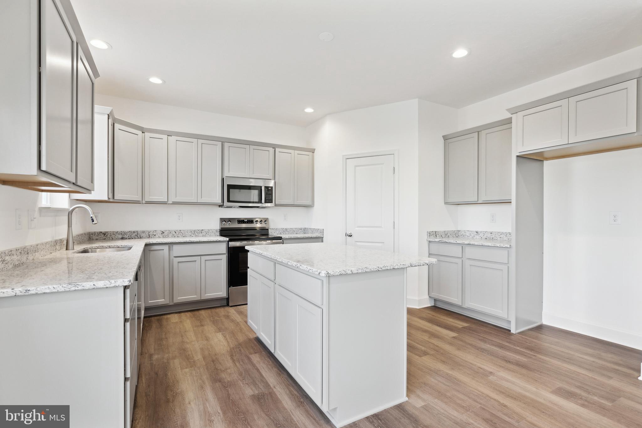 65 Eagle Drive Hanover, PA 17331 - Photo 11 of 26 a kitchen with granite countertop white cabinets and white appliances