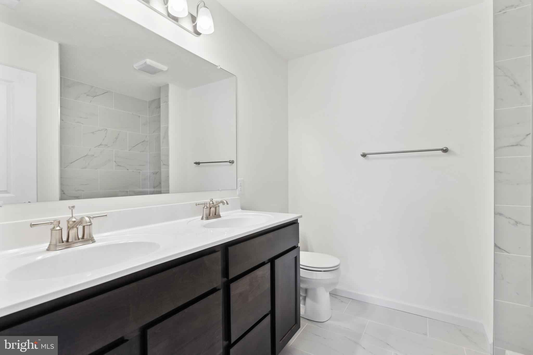 65 Eagle Drive Hanover, PA 17331 - Photo 16 of 26 a bathroom with a double vanity sink toilet and a mirror