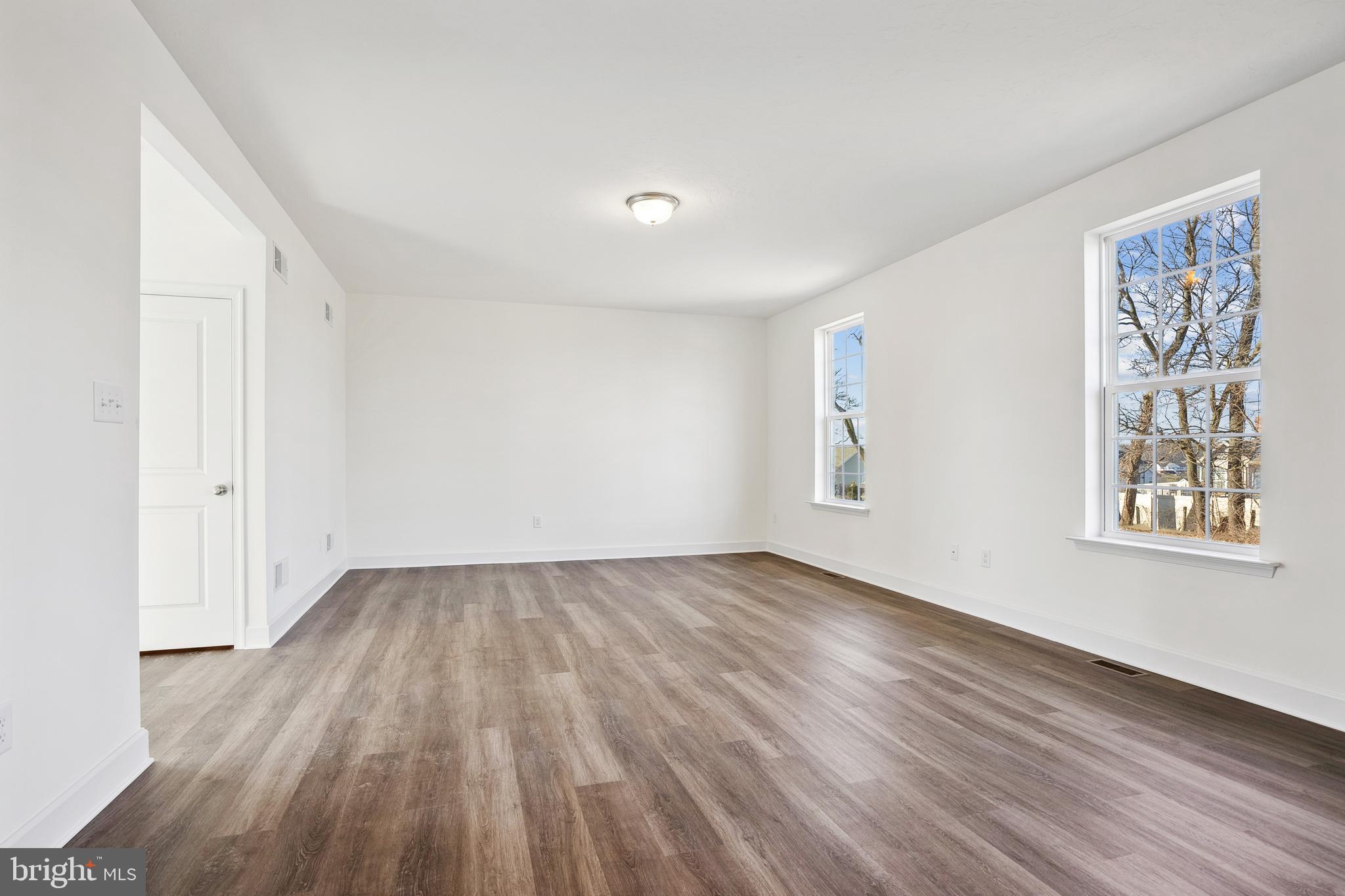65 Eagle Drive Hanover, PA 17331 - Photo 7 of 26 an empty room with wooden floor and windows