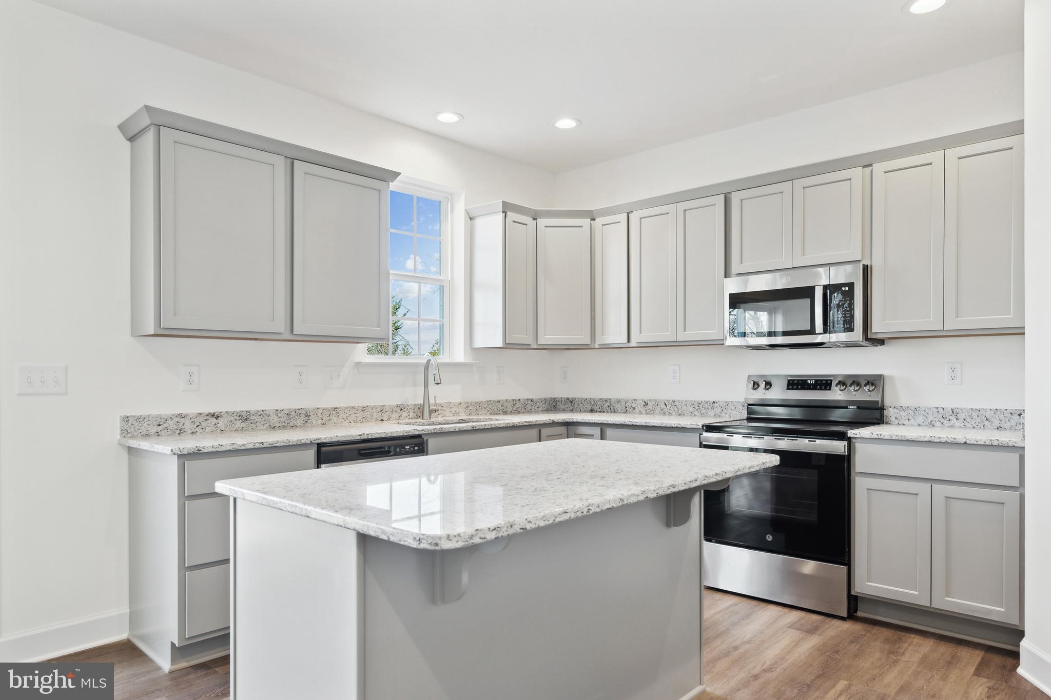 65 Eagle Drive Hanover, PA 17331 - Photo 10 of 26 a kitchen with stainless steel appliances granite countertop a sink stove a microwave and cabinets