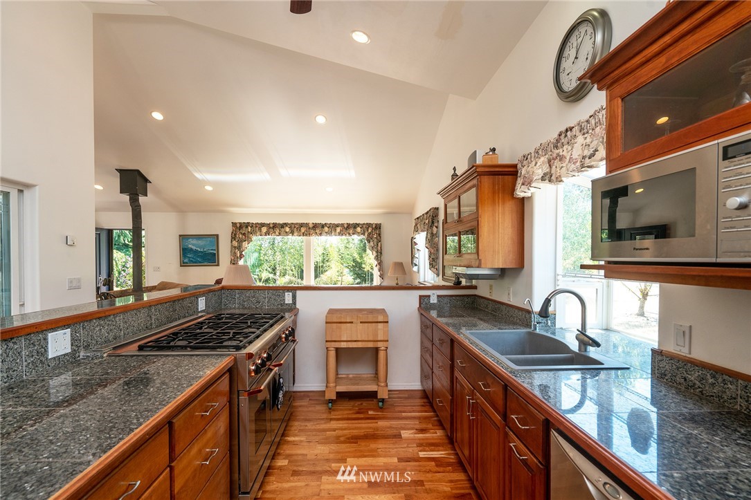 1976 Center Road Lopez Island, WA 98261 - Photo 12 of 26 a kitchen with stainless steel appliances granite countertop a sink and stove