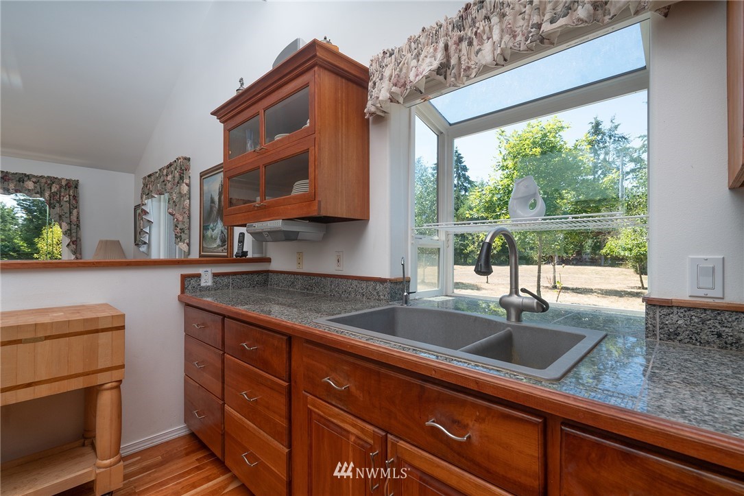 1976 Center Road Lopez Island, WA 98261 - Photo 13 of 26 a kitchen with granite countertop a sink a counter space and cabinets