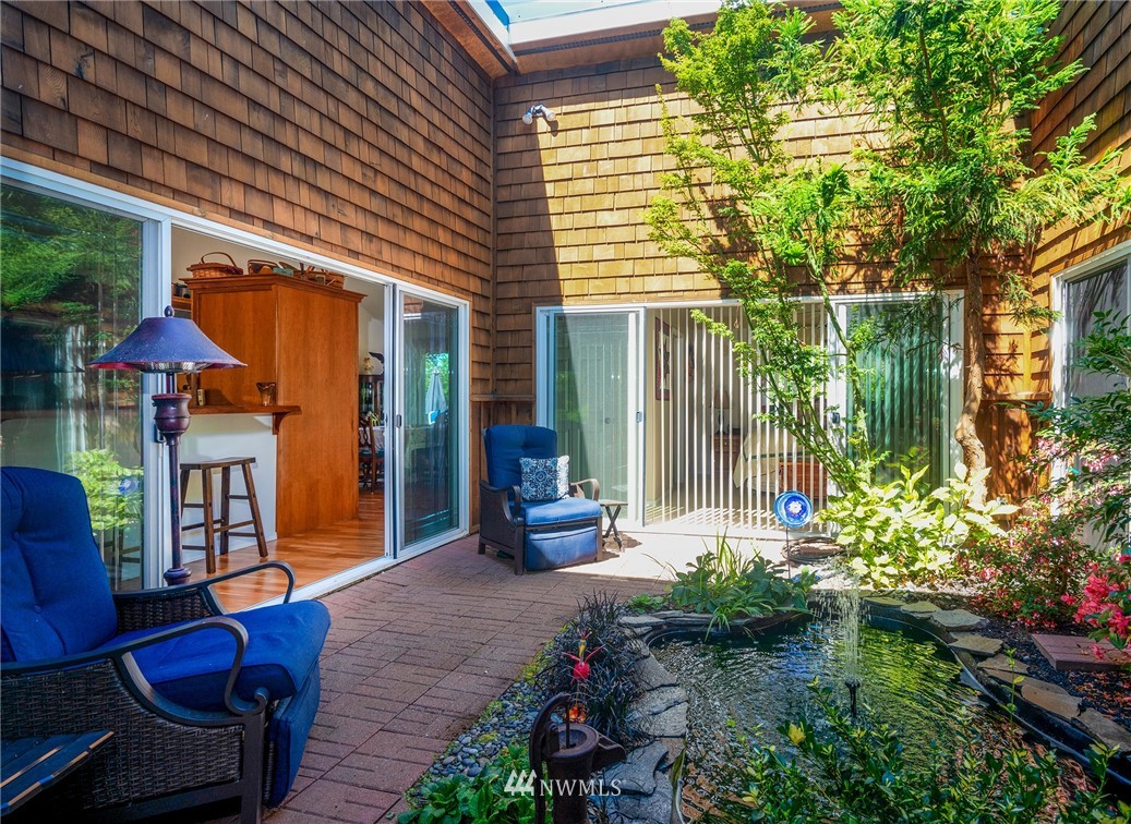 1976 Center Road Lopez Island, WA 98261 - Photo 19 of 26 a view of a patio with couches table and chairs and potted plants