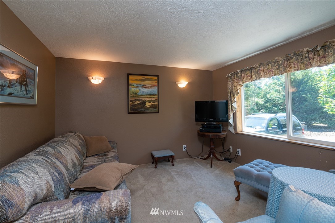 1976 Center Road Lopez Island, WA 98261 - Photo 22 of 26 a living room with furniture and a flat screen tv