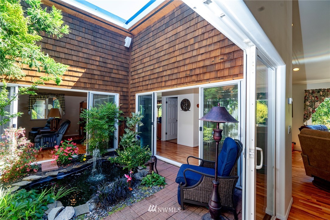 1976 Center Road Lopez Island, WA 98261 - Photo 9 of 26 a view of patio with a table and chairs and potted plants