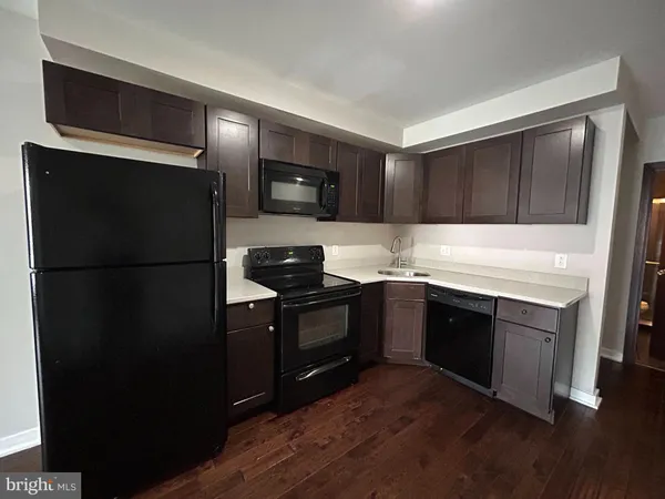 a kitchen with a refrigerator stove and sink