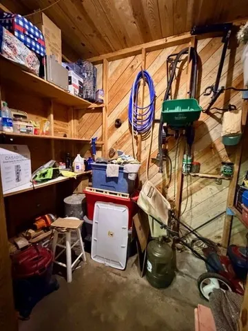 a storage room with lots of clutter and chairs