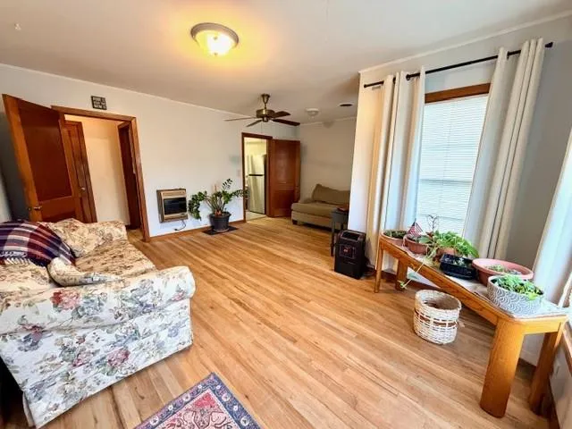 a bedroom with bed and wooden floor
