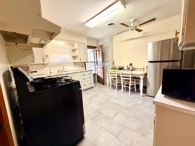 1417 Reynolds Street Goldthwaite, TX 76844 - Photo 7 of 21 a view of a dining room with furniture a kitchen and chandelier