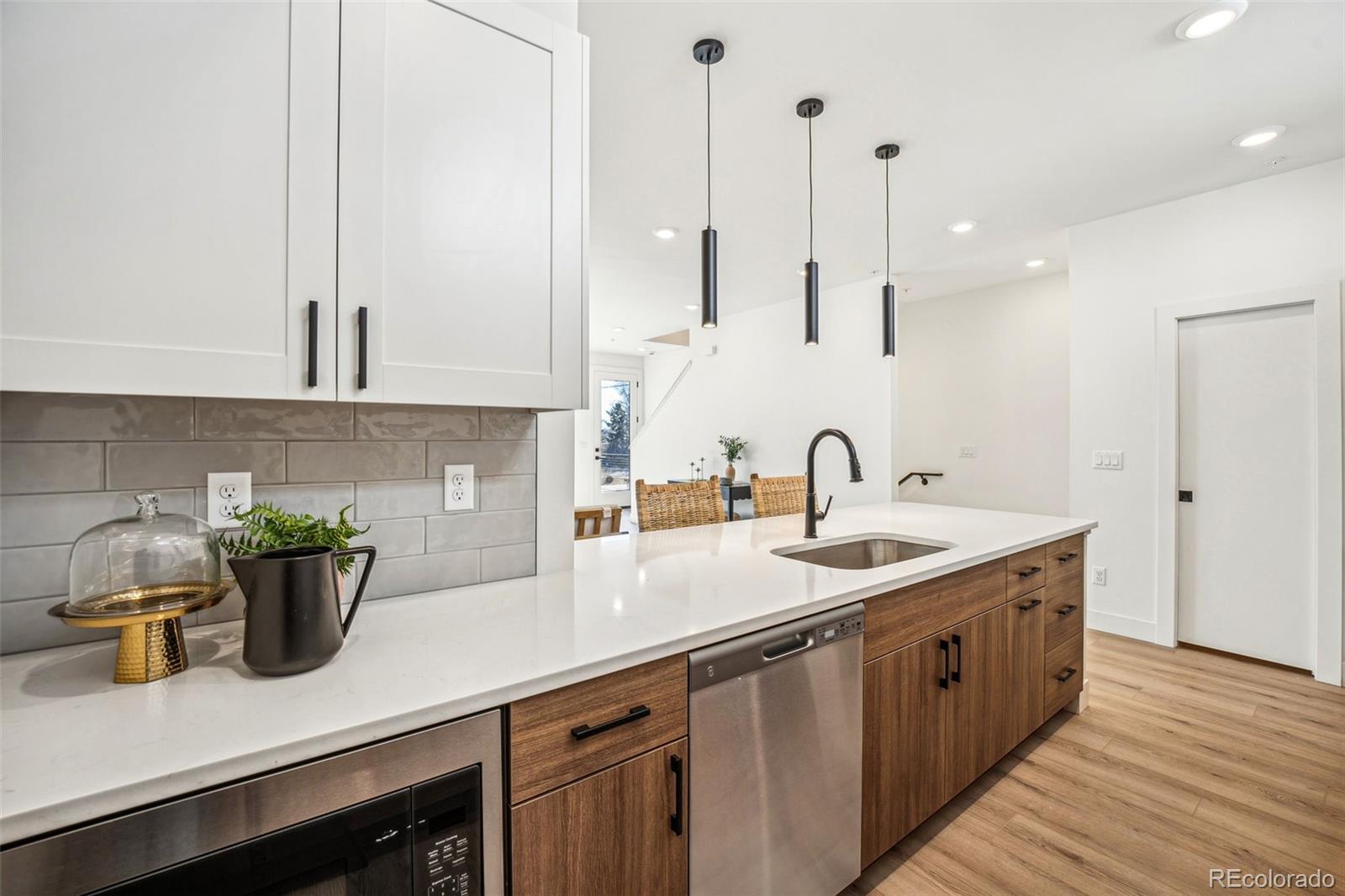 1416 Pierce Street Lakewood, CO 80214 - Photo 11 of 38 a kitchen with sink and a potted plant