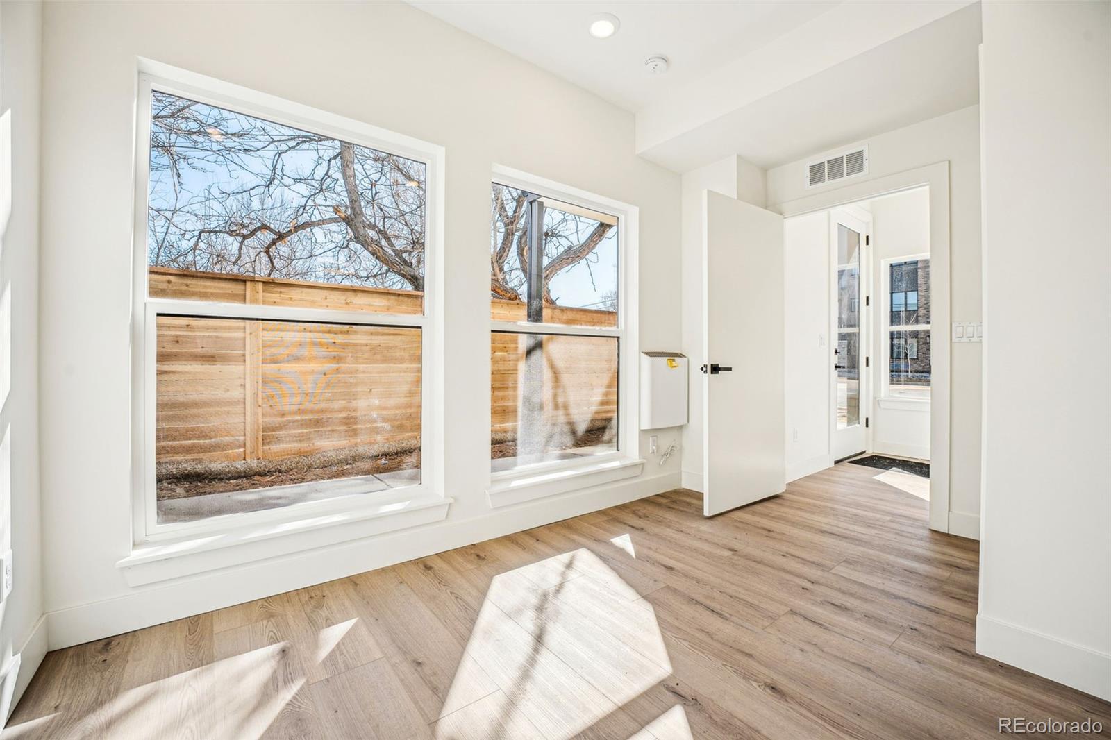 1416 Pierce Street Lakewood, CO 80214 - Photo 13 of 38 a view of an empty room with wooden floor and a window