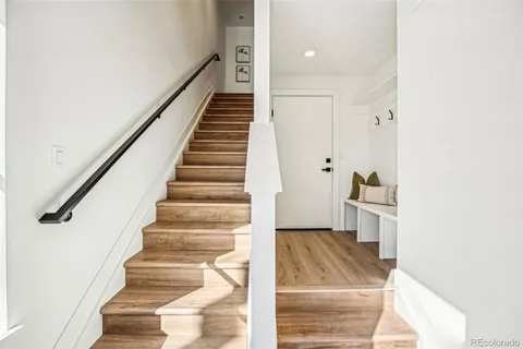 a view of entryway and hall with wooden floor