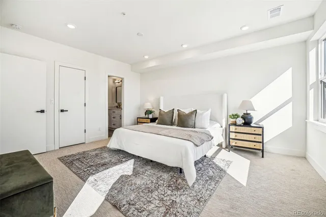 a bedroom with a bed and a dresser