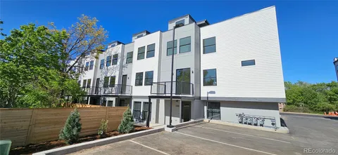 a view of a tall building next to a road
