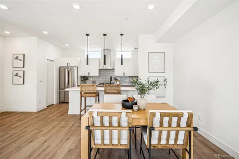 a view of a dining room with furniture and wooden floor