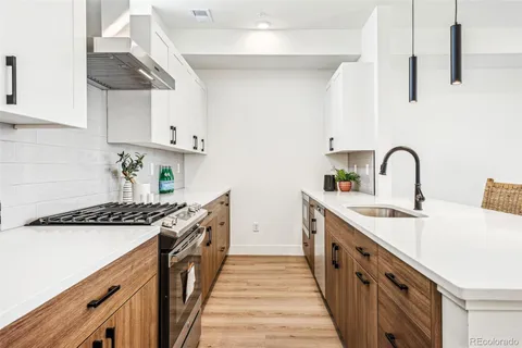 a kitchen with stainless steel appliances a sink stove and cabinets