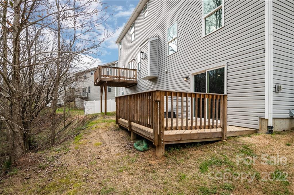 7740 East Berkeley Road Denver, NC 28037 - Photo 16 of 18 a view of a house with a yard and wooden fence